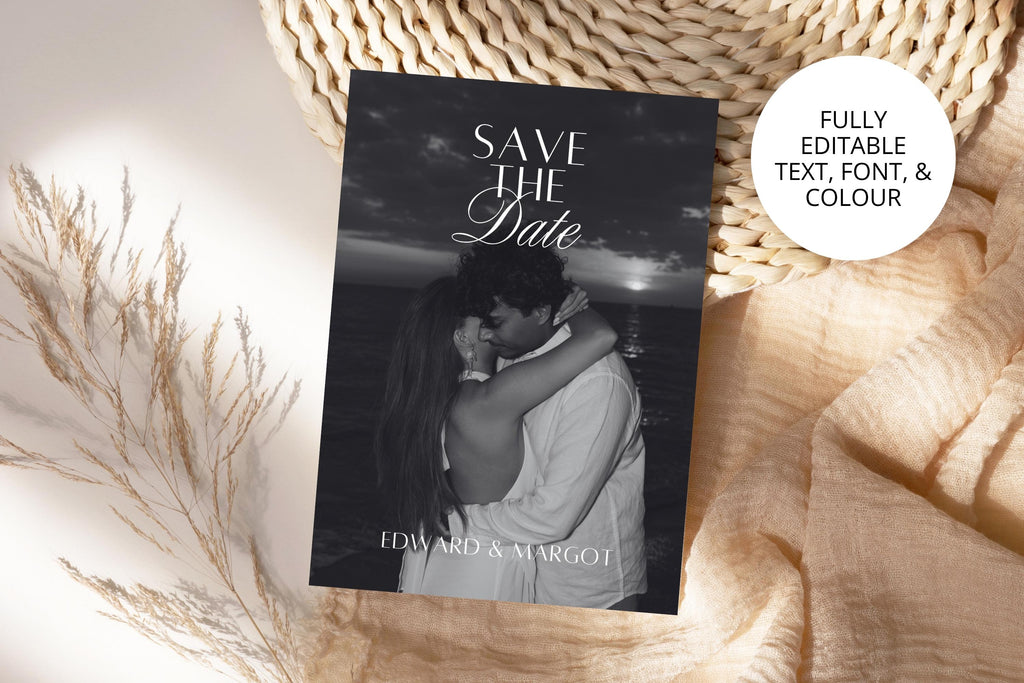 Editable photo wedding save the date card with black and white couple portrait and elegant script lettering, styled beside dried stems and cream fabric, with customisable text, fonts and colours.