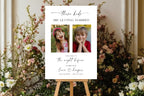 Personalised wedding photo sign on an easel, featuring a couple’s childhood photos and burgundy floral wedding styling.