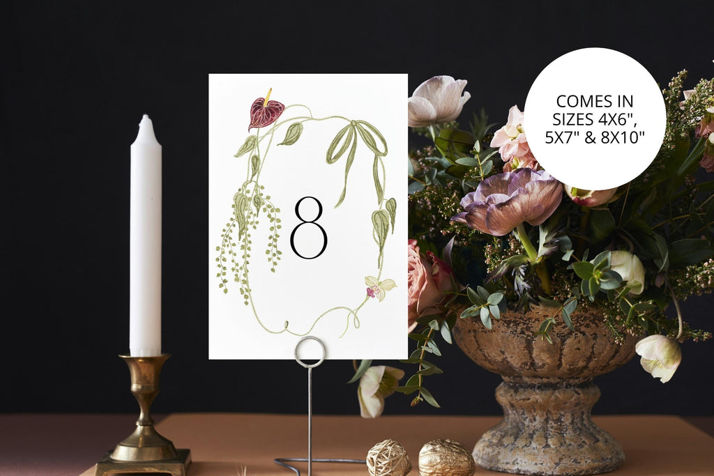 Printable botanical wedding table number eight displayed beside a taper candle and elegant floral centrepiece, available in three sizes.