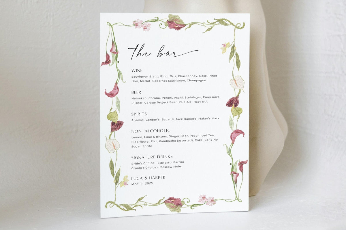 Editable floral wedding bar menu template with drinks listed beneath “the bar” heading, framed by delicate pink flowers and green foliage for elegant reception drinks signage.