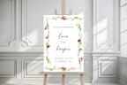 Elegant floral wedding welcome sign template displayed on easel, printable botanical ceremony entrance sign with burgundy orchids, greenery and modern calligraphy