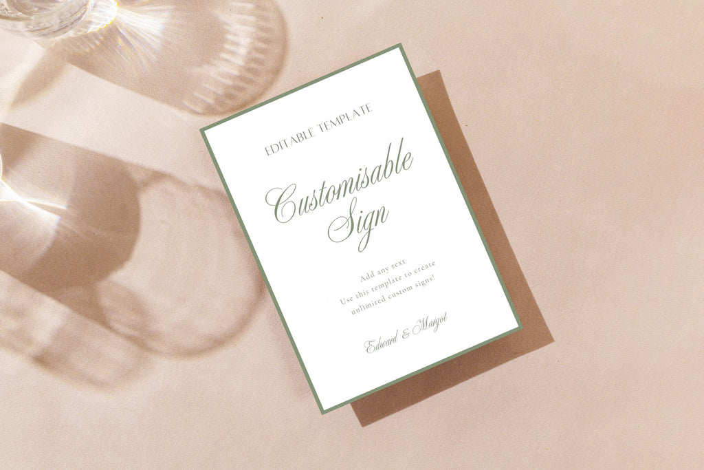 Sage green wedding sign mockup with a thin green border and elegant script lettering, displayed on soft blush fabric; editable wedding reception sign.