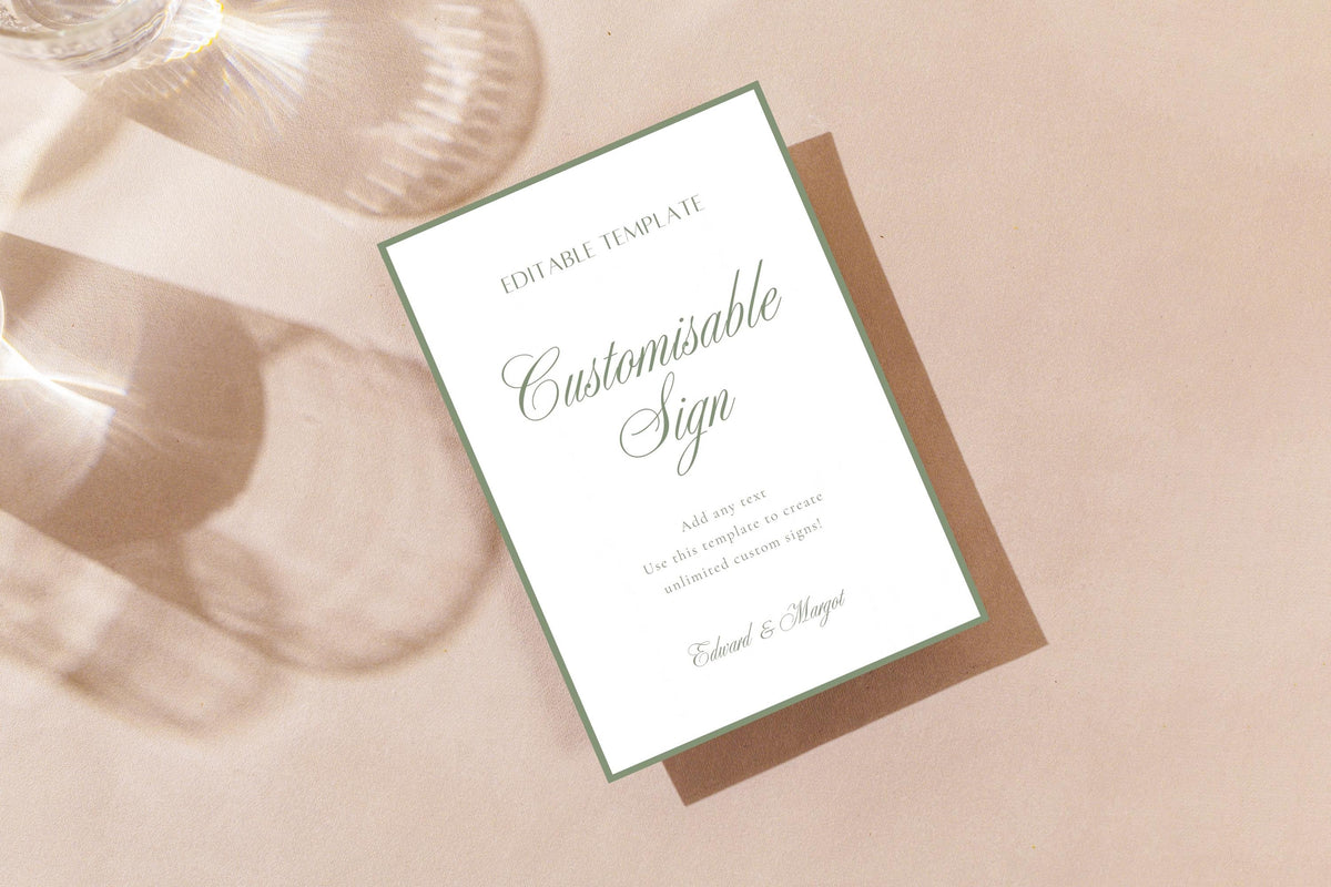 Sage green wedding sign mockup with a thin green border and elegant script lettering, displayed on soft blush fabric; editable wedding reception sign.