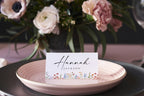 Elegant wildflower place card template displayed on wedding dinner plate, printable escort card, rustic boho floral table name cards