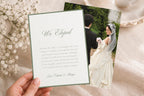 Editable elopement announcement card mockup showing a hand holding a white “We Eloped” card with a slim sage green border, paired with a wedding photo card in a soft neutral setting.