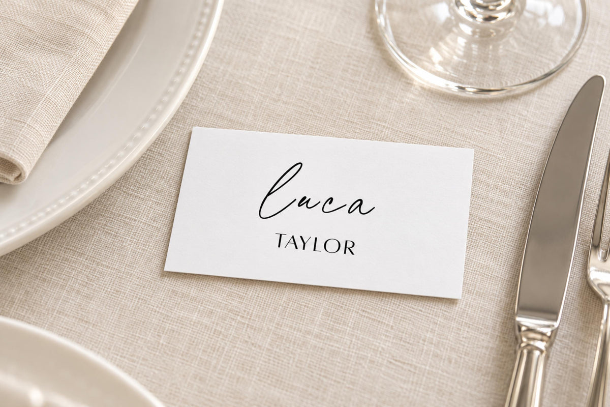 Printable flat wedding place card template featuring modern calligraphy and clean typography on a beige linen wedding table setting.