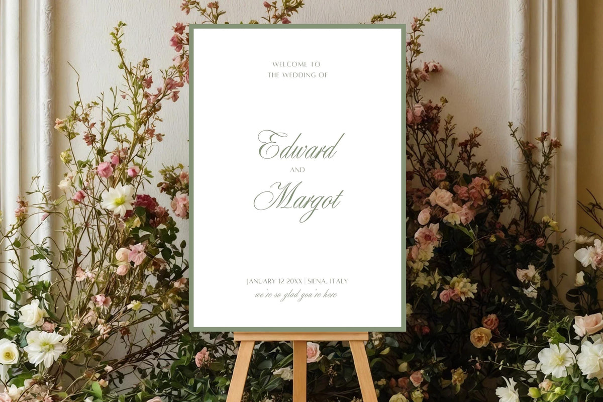 Romantic sage green wedding welcome sign on a wooden easel surrounded by airy pink, ivory and burgundy flowers. Elegant script names and a fine green border complement a colourful garden wedding entrance display.