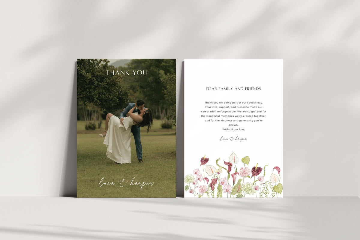Elegant photo wedding thank you card front and floral message reverse displayed upright in natural light. Personalised newlywed stationery with a full photo design and pink wildflower illustration on the back.