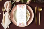 Long floral wedding menu card styled on a blush pink plate with gold cutlery and soft neutral linen for an elegant spring or garden wedding reception.