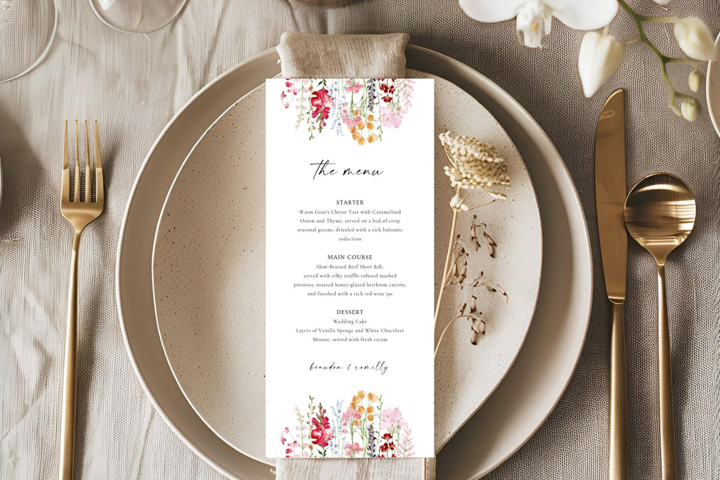Romantic floral wedding menu card styled on a neutral plate with gold cutlery and linen, ideal for elegant wedding reception table décor.