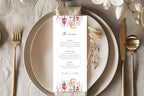Romantic floral wedding menu card styled on a neutral plate with gold cutlery and linen, ideal for elegant wedding reception table décor.