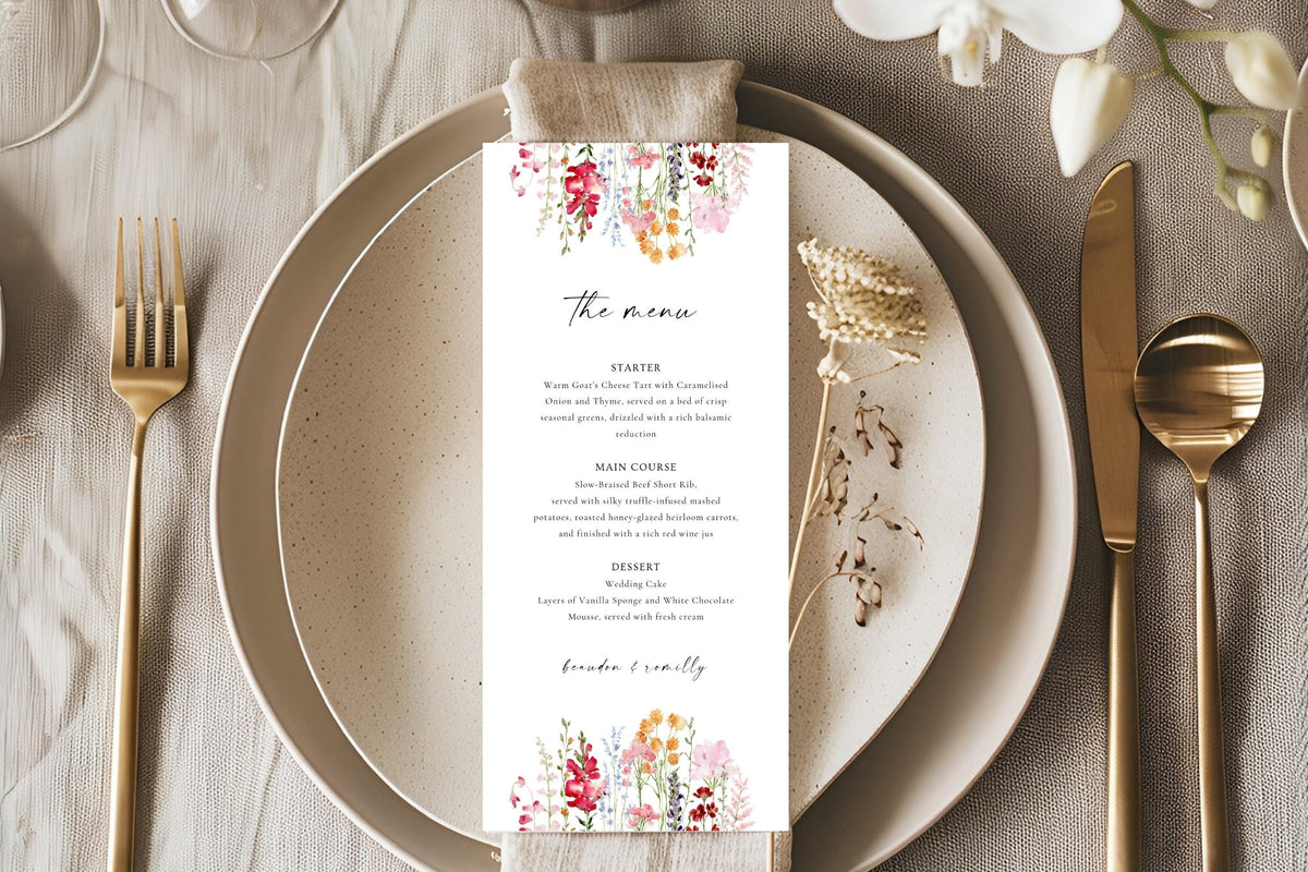 Romantic floral wedding menu card styled on a neutral plate with gold cutlery and linen, ideal for elegant wedding reception table décor.
