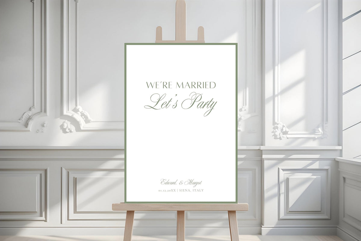 Sage bordered “We’re Married, Let’s Party” wedding welcome sign displayed on an easel in a bright, elegant interior with white panelled walls.