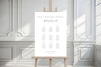Minimalist wedding seating chart template on easel in bright white interior, clean modern Canva seating plan sign, editable wedding signage printable, classic elegant wedding seating display