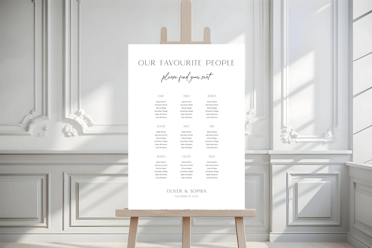 Minimalist wedding seating chart template on easel in bright white interior, clean modern Canva seating plan sign, editable wedding signage printable, classic elegant wedding seating display