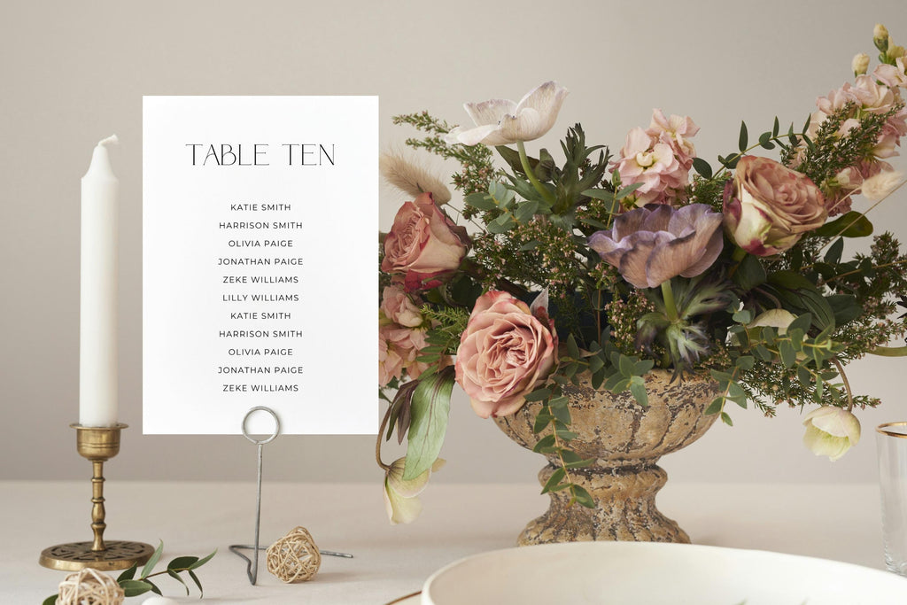 Editable wedding seating chart card template styled in luxury wedding tablescape mockup, minimalist wedding reception signage, elegant table assignment printable, modern black serif font seating card