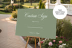 Sage green custom wedding sign mockup showing two design variations included, styled outdoors with a garden ceremony backdrop.