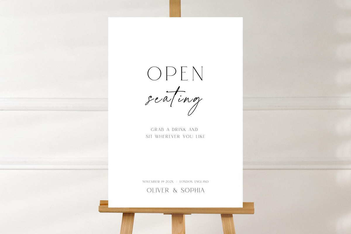 Editable open seating wedding sign mockup on wooden easel, minimalist wedding reception seating sign template, black and white modern wedding signage, printable open seating wedding decor, instant download Canva template, elegant reception entrance sign.