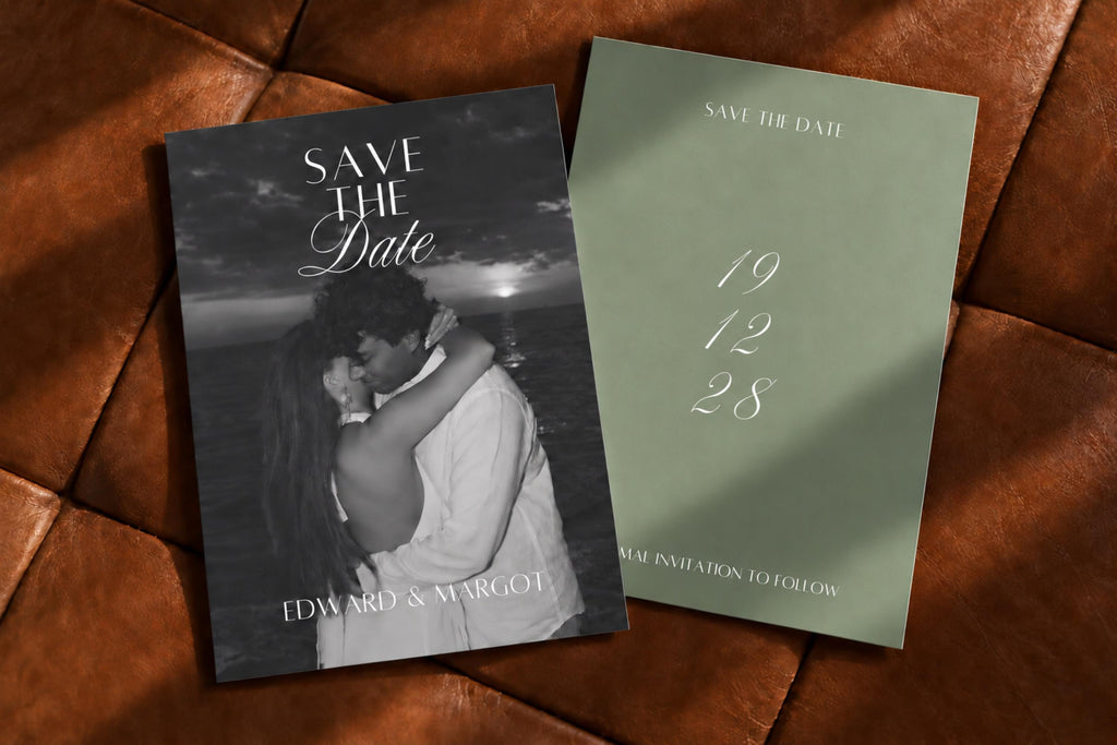 Old money wedding save the date cards on brown leather, featuring a black and white engagement photo front and minimalist sage green back with white script wedding date.