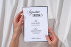 Editable signature drinks wedding sign Canva template shown handheld, printable minimalist wedding cocktail menu, instant download wedding bar sign, modern reception signage