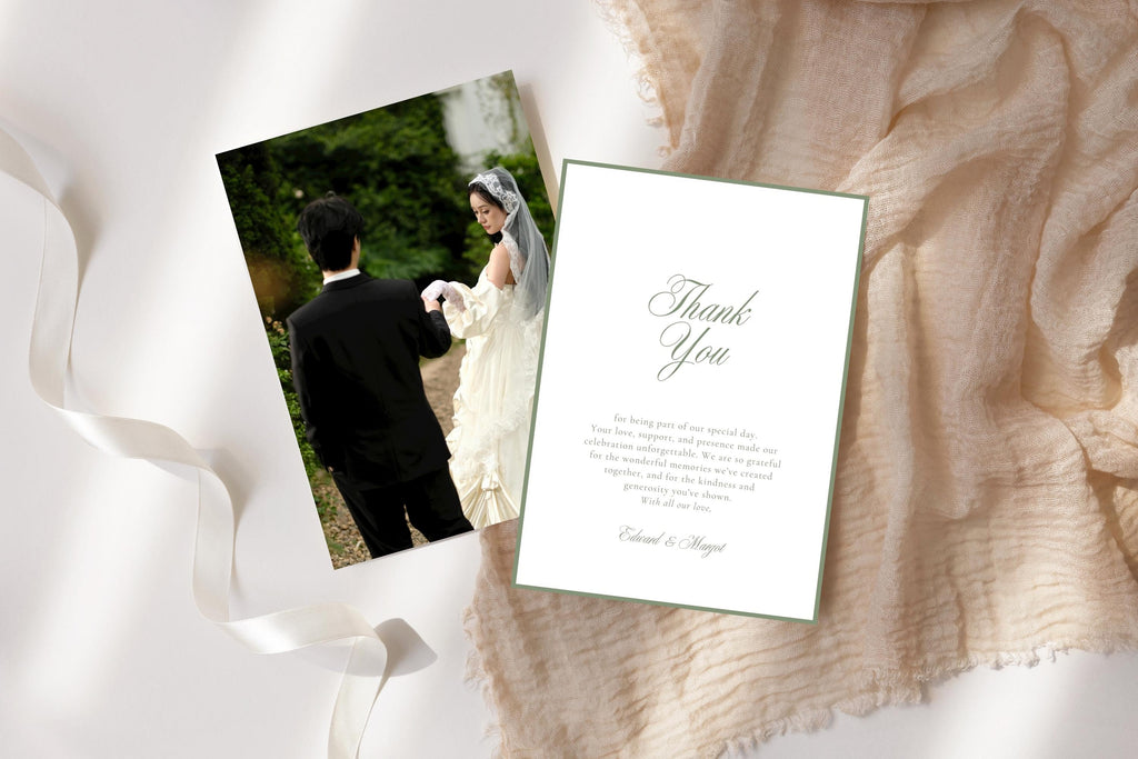 Printable wedding photo thank you card template with a sage green bordered message design, styled beside a bride and groom photograph on soft neutral fabric with flowing white ribbon.