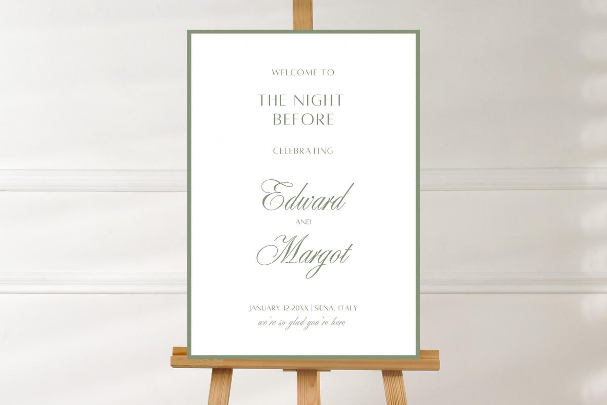 White and sage green “The Night Before” rehearsal dinner sign featuring a thin green border, classic serif lettering and script names. Minimalist wedding welcome sign displayed on a wooden easel against a neutral wall.