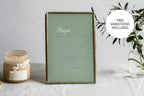 Sage green wedding vows keepsake print with white script lettering in a gold frame beside candles and greenery, showing a romantic colour variation for wedding anniversary home décor.