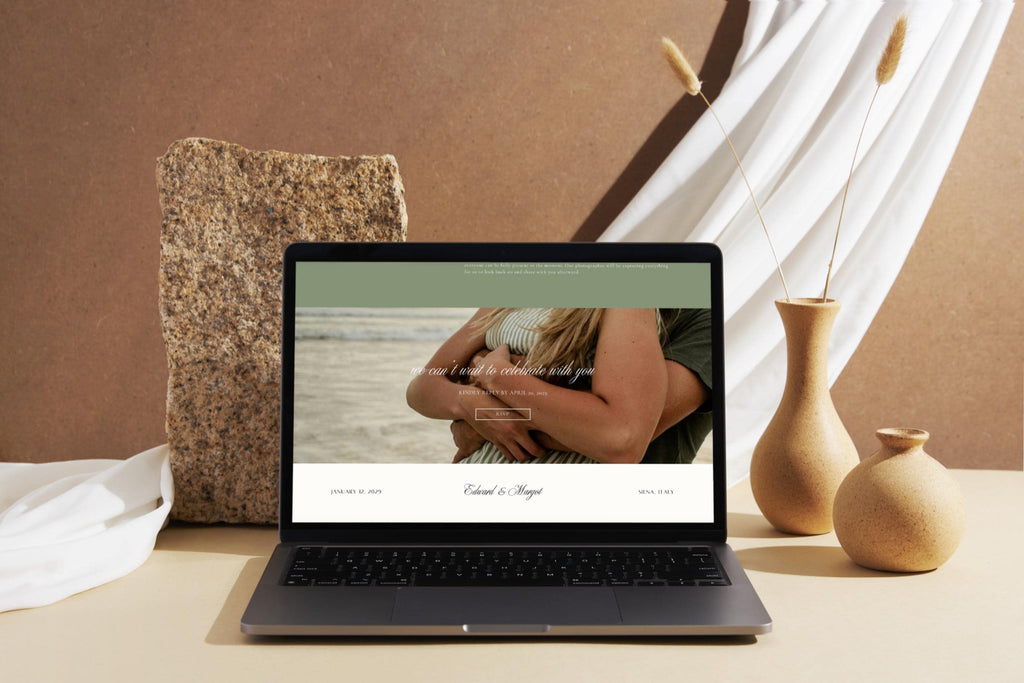 Romantic old money wedding website template displayed on a laptop, featuring a couple photograph, sage green accents and elegant typography in a neutral setting.