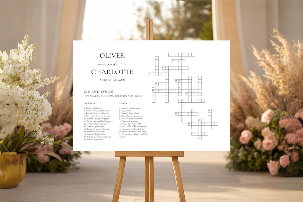 Minimalist sip and solve wedding crossword sign displayed on an easel at a romantic wedding venue, personalised with couple names and date, elegant neutral printable wedding game for reception or cocktail hour