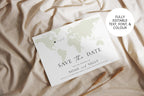 Flat lay of world map save the date template in earthy tones, editable Canva design for modern destination wedding invitations.