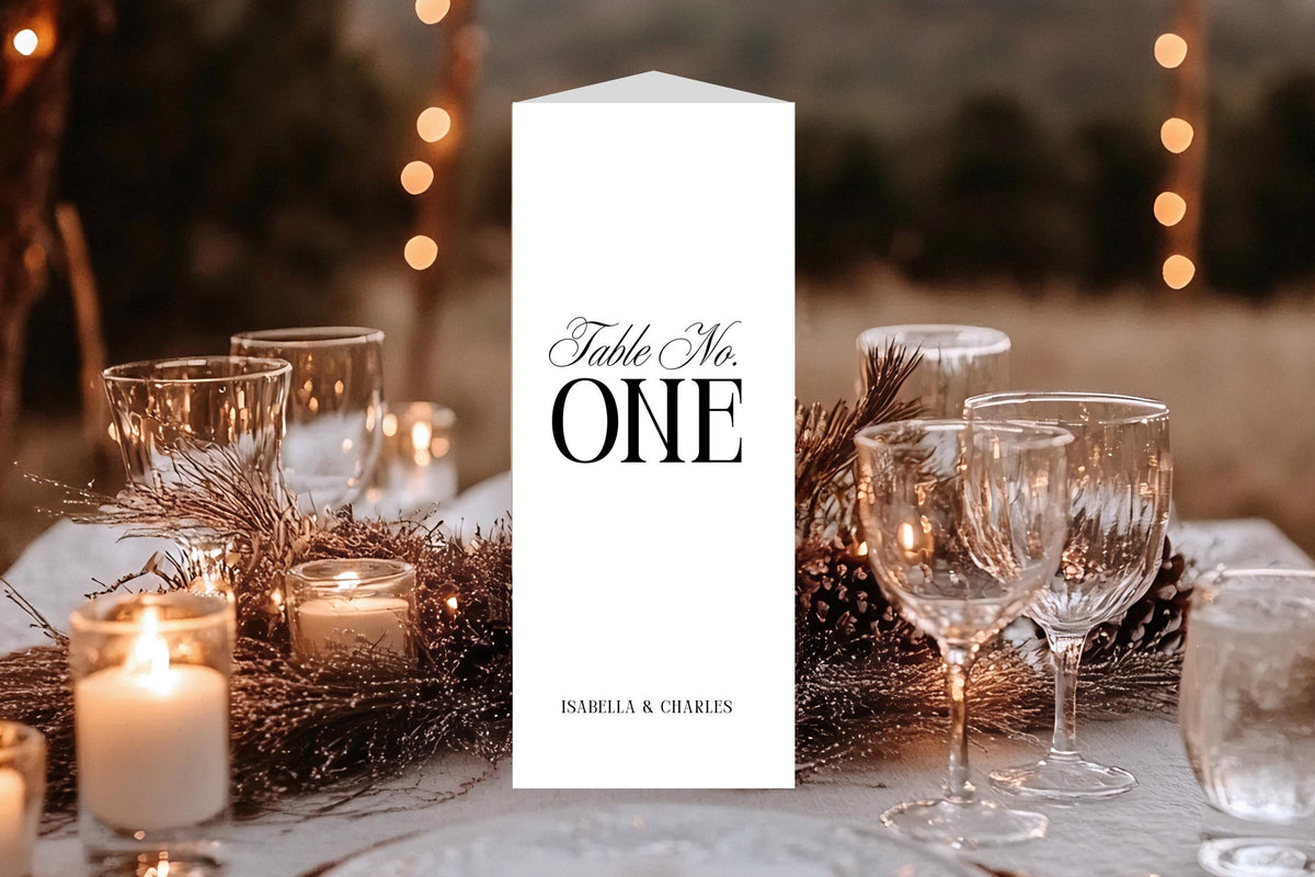 Elegant trifold wedding table number with menu and bar layout displayed on a candlelit reception table, classic old money wedding stationery style, minimalist black and white table decor printable