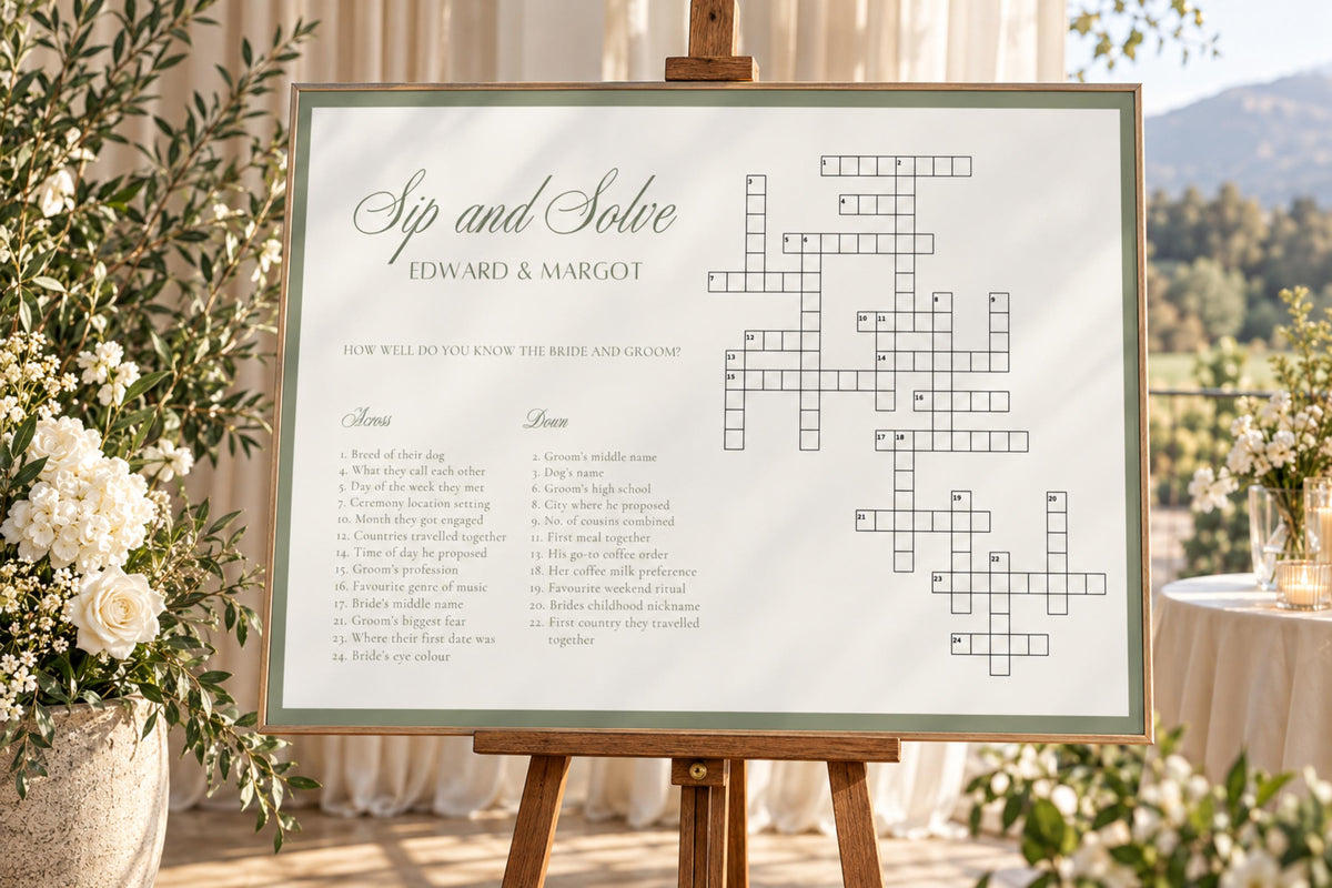 Sage framed Sip and Solve wedding activity sign displayed on an easel at a sunlit outdoor wedding venue with trees and garden greenery.