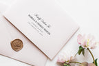 Close-up of wedding envelope addressing template with elegant script and serif fonts, blush envelopes, wax seal, old money wedding stationery design editable in Canva.