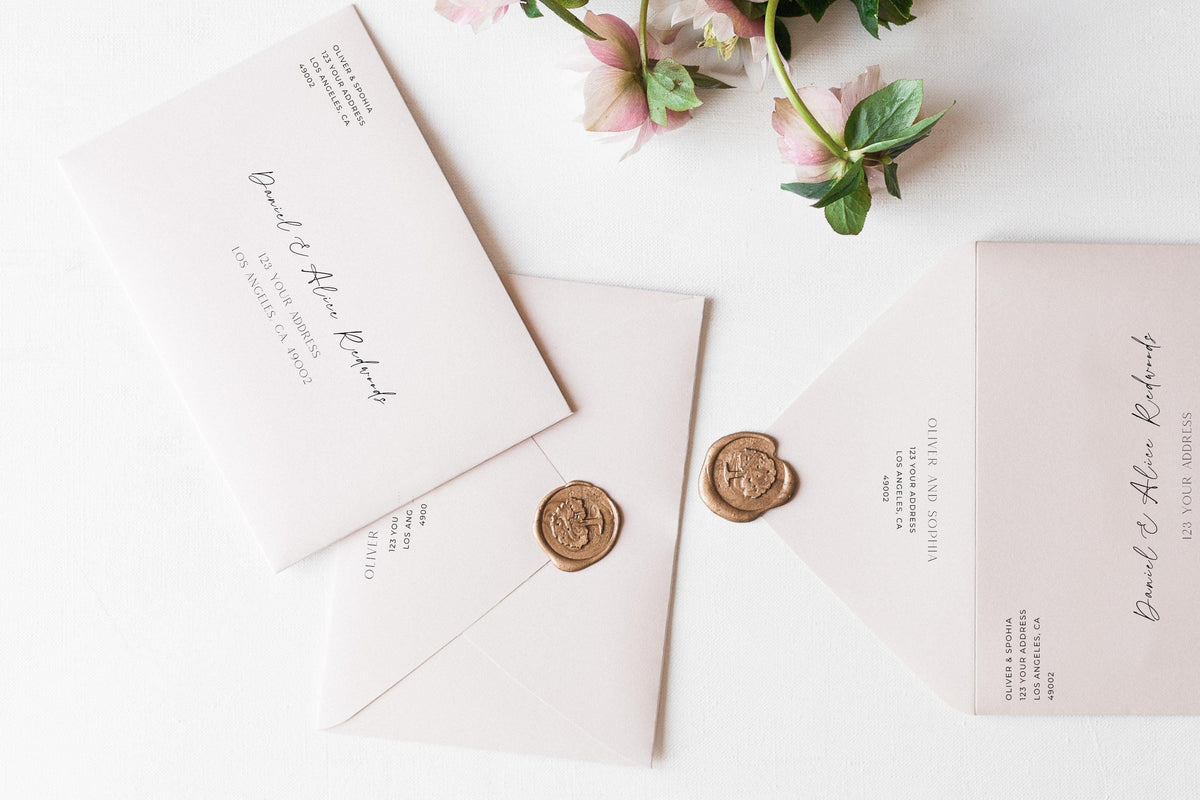 Flat lay wedding envelope addressing set with wax seals and blush florals, modern calligraphy wedding envelope template, minimalist editable Canva wedding stationery design