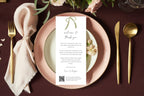 Sage green bow wedding thank you letter displayed on blush pink plates with gold cutlery and a burgundy tablecloth. Editable wedding reception thank you card template for a romantic dinner place setting.