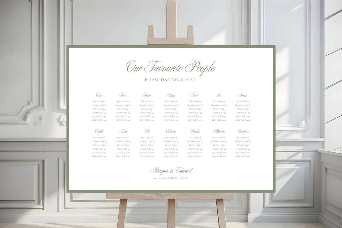 Minimalist landscape wedding seating chart template with a sage green border displayed on an easel in front of elegant white panelled doors.
