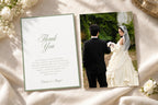 Elegant sage green wedding thank you card and matching photo reverse on ivory fabric with white flowers, featuring romantic calligraphy and a classic border for timeless wedding stationery.