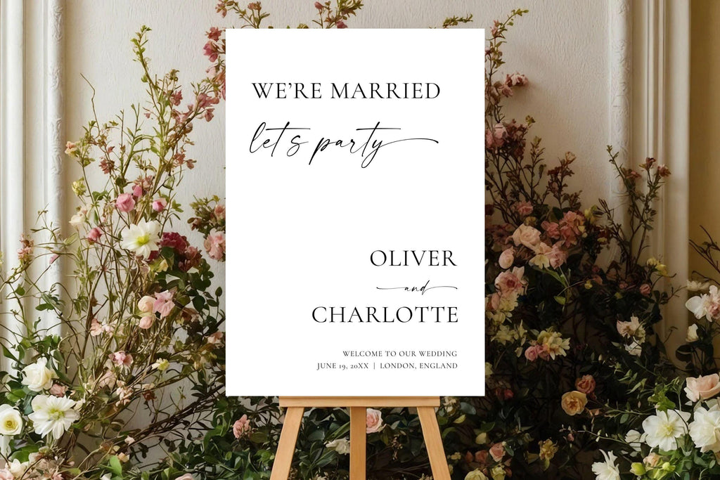 “We’re Married, Let’s Party” wedding sign displayed on easel with florals, minimalist wedding reception sign Canva template for modern weddings