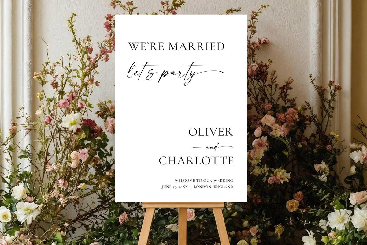 “We’re Married, Let’s Party” wedding sign displayed on easel with florals, minimalist wedding reception sign Canva template for modern weddings